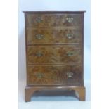 An early 20th century bleached burr walnut serpentine front chest of 4 drawers, raised on bracket