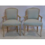 A pair of French beech wood fauteuil