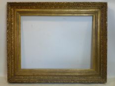 A large ornate gilt wood picture frame, 108 x 136cm outer, 78 x 106cm inner