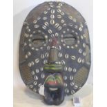 A 20th century African tribal mask, with cowrie shells, beads and copper inlay, H.52 W.37cm