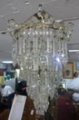 A gilt metal and glass drop chandelier together with a pair of matching wall lights