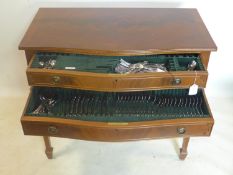 A 20th century mahogany canteen table with stainless steel cutlery, retailed by Asprey, H.79 W.89