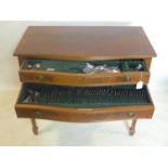 A 20th century mahogany canteen table with stainless steel cutlery, retailed by Asprey, H.79 W.89