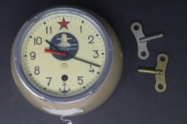 A Russian bulkhead clock by Kuamqupckue, the round dial with Arabic numerals, signed to dial and