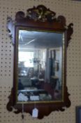 A Georgian fretwork mirror, with pierced scrolling design and gilt phoenix motif, having ghosted