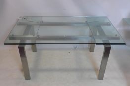 An Italian glass extending dining table by Pedrali, H.65 W.160 D.90cm (not extended)