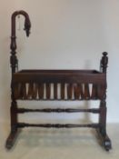 A Victorian mahogany rocking crib on stand, with swan neck finial, H.103 W.104 D.59cm