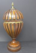 A Regency style mahogany urn and cover with brass finial, H.36cm