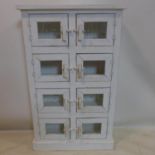 A contemporary white painted cabinet with 8 glazed doors, H.105 W.64 D.20cm
