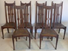 A set of six Arts & Crafts oak dining chairs, possibly Liberty's, with leather covered rush seats