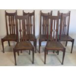 A set of six Arts & Crafts oak dining chairs, possibly Liberty's, with leather covered rush seats