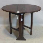 An Art Deco oak drop leaf gate leg table