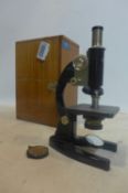 A vintage 'Prior' microscope in wooden travel case