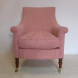 A Regency style armchair with red Gingham upholstery, raised on turned mahogany legs and castors