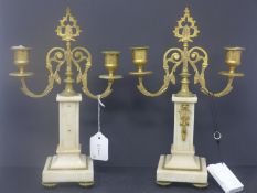 A pair of gilt metal and alabaster candlesticks, H.32cm