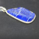 A large sterling silver and natural lapis lazuli pendant to silver pendant loop, 6.5 x 3.5cm, 32.5g