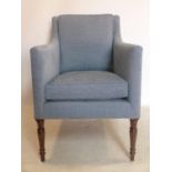 A Regency style armchair with blue corduroy upholstery, raised on turned legs