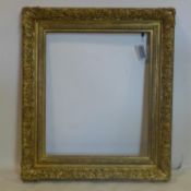 An ornate gilt wood picture frame, 78 x 91cm outer, 56 x 66cm outer