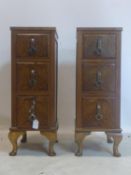 A pair of Art Deco walnut pedestal chests, with three short drawers, on cabriole feet, H.78 W.28 D.