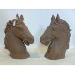 A pair of cast iron gate piers modelled as horse heads, H.47cm (2)