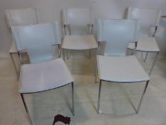 A set of 5 designer white leather and stainless steel chairs