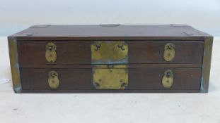 A late 19th/early 20th century Korean table top chest, brass bound with 2 drawers and handles, H.