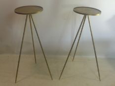 A pair of contemporary gilt metal cocktail tables, with circular tops raised on three splayed