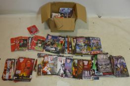 A collection of 2000 AD comic books, together with football programmes and booklets and an Arsenal