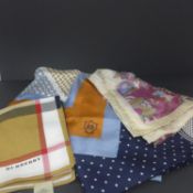 A collection of four scarves, to include a cotton Burberry scarf, a Massimo Dutti Italian silk scarf