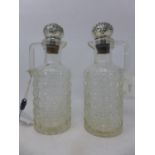 A pair of late 19th century glass claret jugs with silver stoppers, circa 1892, H.26cm