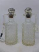 A pair of late 19th century glass claret jugs with silver stoppers, circa 1892, H.26cm