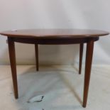 A 20th century teak dining table raised on tapered legs, H.73 D.120cm