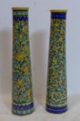 Two Persian Isfahan bamboo vases, decorated with stylised flowers, one with firing crack to base,