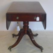 An early 19th century mahogany pembroke table, with single drawer, raised on turned support, 4