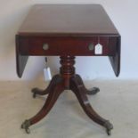 An early 19th century mahogany pembroke table, with single drawer, raised on turned support, 4