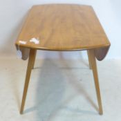 An Ercol elm drop flap dining table, H.72 L.112cm