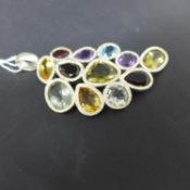 A sterling silver, large palmette pendant collet set with faceted garnet, smokey quartz, citrine,