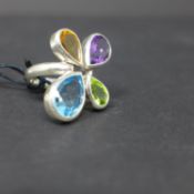 A sterling silver ring set with 4 pear-drop shaped faceted stones to include blue topaz, citrine,