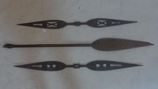 A pair of early 20th century Polynesian Tribal canoe paddles together with one other