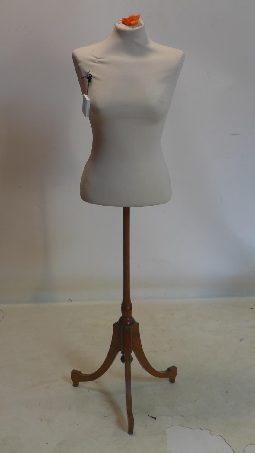 A modern mannequin on 19th century mahogany base