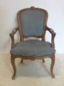 An early 20th century French walnut child's fauteuil