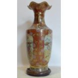 A Japanese Satsuma style vase, decorated with vignettes of figures, flowers and birds on an orange/