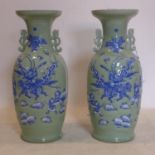 A pair of early 20th century Chinese vases, one broken, decorated in blue and white with warriors in