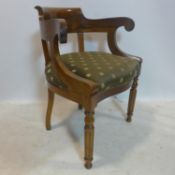 A Regency style teak scroll armchair