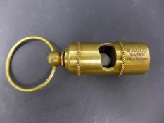 A reproduction brass whistle, marked RMS Titanic, White Star Line, H.6cm