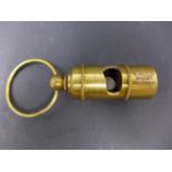 A reproduction brass whistle, marked RMS Titanic, White Star Line, H.6cm