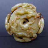 A 19th century Chinese jade paperweight, with pierced carvings of dragons, Diameter 6cm