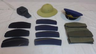 A collection of military hats to include a Blue Russian Soviet military officers cap, a Finnish