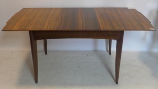 A mid 20th century Waring & Gillows walnut extending dining table, H.75 W.168 D.83cm, together