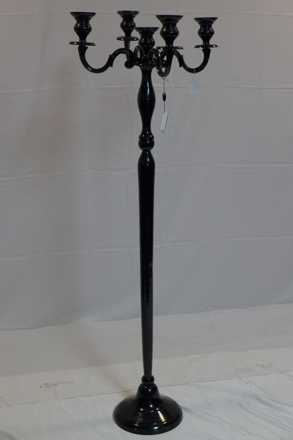 A contemporary floor standing black painted metal candelabra, H.155cm